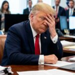 Trump facepalming himself with high stress